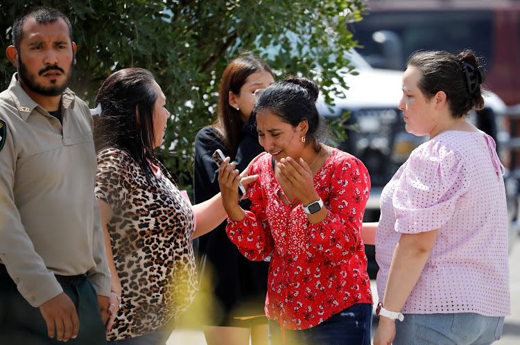 A woman reacts outside the Sgt Willie de Leon Civic Center, where students had been transported from Robb Elementary School after a shooting, in Uvalde, Texas, on May 24 2022.