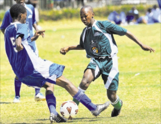 THE BALL IS MINE: Itumeleng Makau and Makhwenkodwa Ntlanyana fight for the ball during the Sasfa Metropolitan Schools Cup at Mamelodi sports ground. Rosina Sedibane beat Harmony 1-0 (Photo first published 09/10/2011