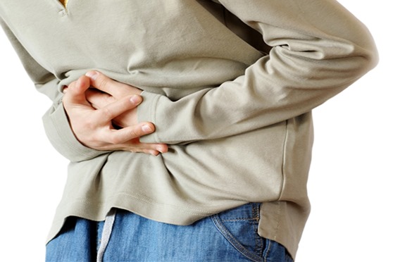 boy holding hands on his stomach over white background, pain