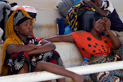 Women sit inside a displacement centre after fleeing an attack claimed by Islamic State-linked insurgents on the town of Palma, in Pemba, Mozambique, on April 2 2021. 