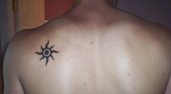 small tribal sun tattoo on the upper backs of men