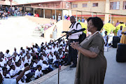 Basic education minister Angie Motshekga talks to parents and pupils at Cosmo City Primary during the first day at school for inland provinces.