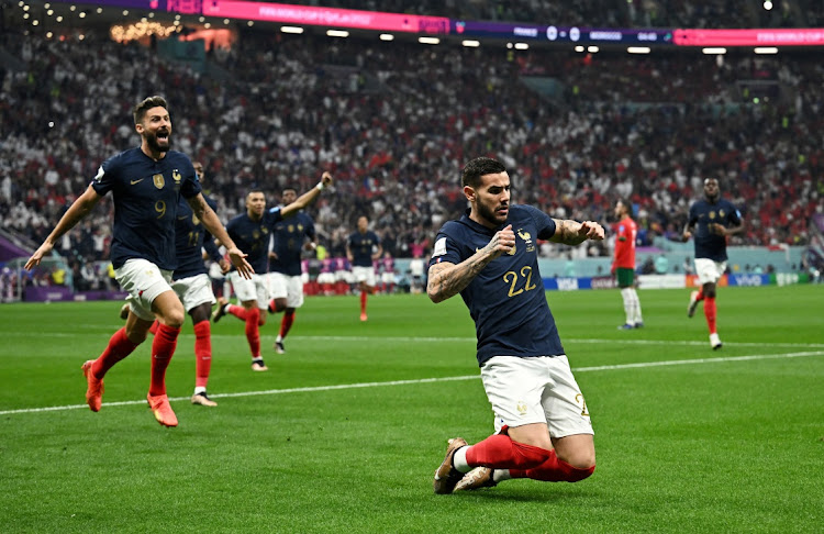 France's Theo Hernandez celebrates scoring their first goal with teammate Olivier Giroud in their World Cup semifinal win against Morocco at Al Bayt Stadium in Al Khor, Qatar on December 14 2022.