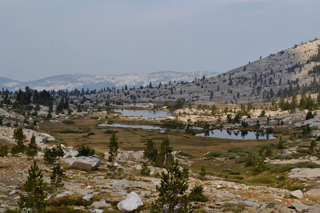 four ponds in the rocks and grass nearing tree line