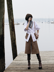 JEFFREY DODD belted pony hair combo jacket in white/sand, pony hair cropped wide leg pant in sand; GUCCI glasses; HERMĒS Animaplois silk scarf; TOD’S blush crossbody bag; DAVIDOR L’Arc de Davidor bangle PM in white gold with palm beach lacquered ceramic, bangle GM in rose gold with flamant lacquered ceramic and palais diamonds, bangle MM in white gold with riviera lacquered ceramic and palais diamonds, bangle GM in rose gold with neige lacquered ceramic and palais diamonds, ring GM in rose gold with flamant lacquered ceramic and porta diamonds, ring GM in white gold with riviera lacquered ceramic and palais dia-monds,  ring GM in white gold with palm beach lacquered ceramic and arcade diamonds, ring GM in yellow gold with neige lacquered ceramic and palais diamonds, ring GM in white gold with hortensia lacquered ceramic and porta diamonds; LONGCHAMP boots