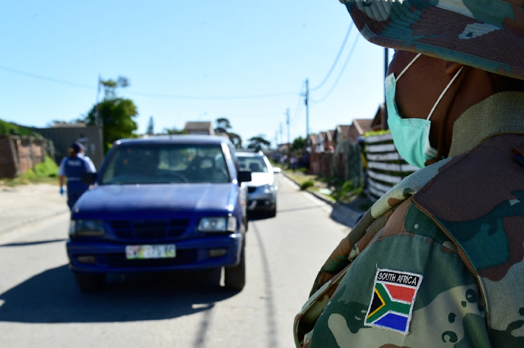 CO-ORDINATED APPROACH: An SANDF soldier looks on as the police screen vehicles travelling in Walmer on Sunday