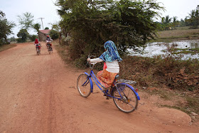 girls wearing hijabs riding bicycles