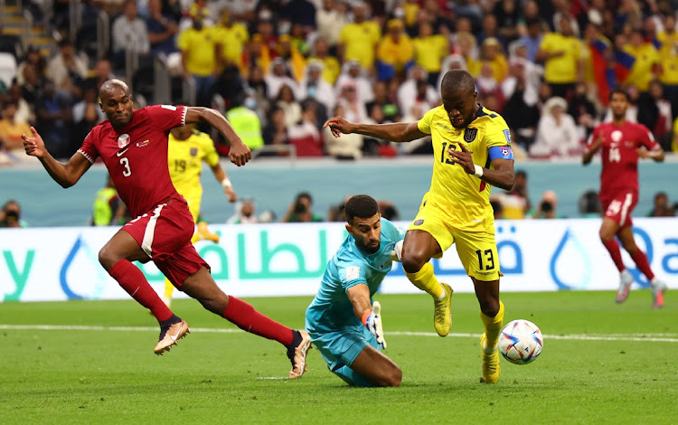 Qatar's Saad Al-Sheeb concedes a penalty against Enner Valencia.