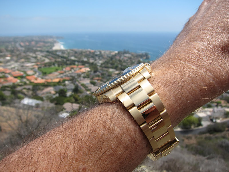 gold submariner on wrist