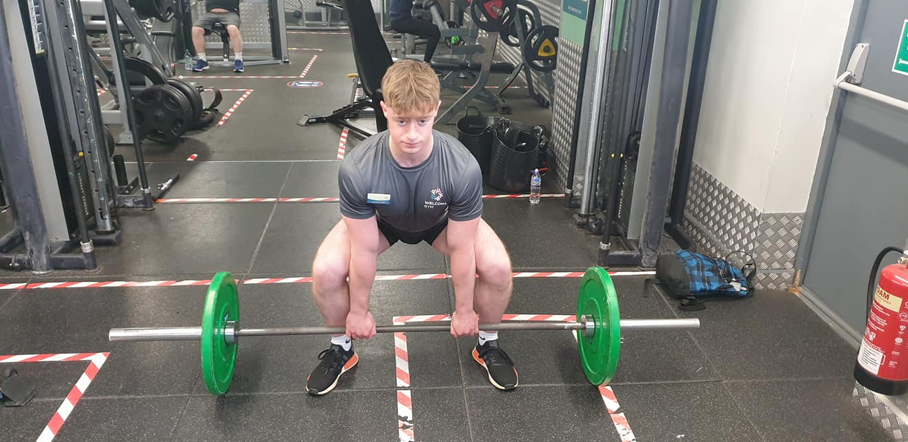 Lifter getting ready for the semi sumo deadlift in a starting position