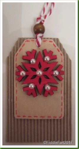 Red snowflake tag with pearl embellishment