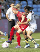 EXPERIENCE: 
       Canada's Carmelina Moscato (left) fights for the ball with  Amanda Dlamini during their women's Group F match at the  Olympics
      
      . 
      PHOTO: REUTERS