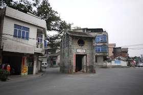 traditional older building isolated in the middle of an intersection