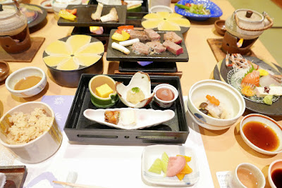 Japanese ryokan kaiseki dinner sets serve in family private room including  appetizer such as cherry blossom tofu, pork shabu hot pot and basket,  sashimi, fried and warm dishes and plum liquor Stock