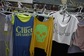 shirts for sale. one says 'so what', another says "AUTHENTC WEAR Cluct LIFE GOES ON", and other has a skull