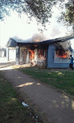Residents of Toekomsrus in Randfontein west set alight a pay point at the municipal building.