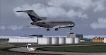 Delta 727-100 landing at Atlanta as an ASA Shorts 360 waits.