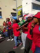 EFF members carrying a coffin draped in ANC colours 