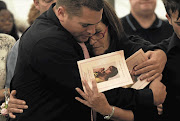 Shireen de Waal, mother of the murdered Louise, is comforted by one of her sons, Justin, at the memorial service for Louise at her school in Roodepoort. File photo.