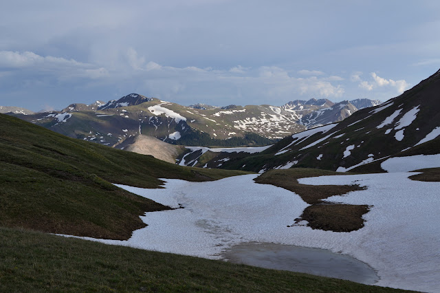 snow on a pond and the view down a new valley