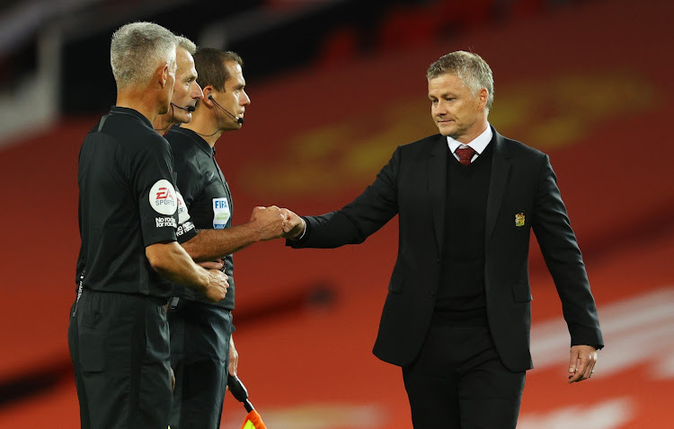 Manchester United manager Ole Gunnar Solskjaer shakes hands with referee Martin Atkinson and assistants during their opening match against Crystal Palace