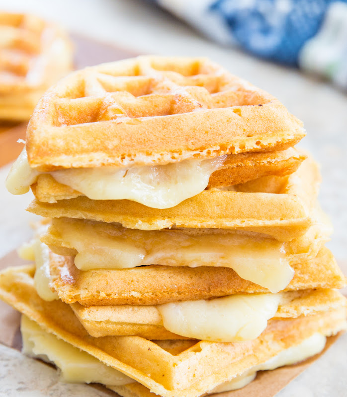 a close-up photo of a stack of waffle grilled cheese sandwiches