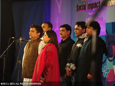 Swanand and Rekha sing the national anthem with the troupe during the Times of India Social Impact Awards, held in Delhi. 