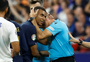 France's Kylian Mbappe with referee Antonio Mateu Lahoz after their Uefa Euro 2024 qualifying Group B match against Greece at Stade de France in Paris on June 19 2023.