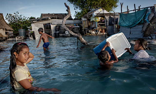 The people of Kiribati are under pressure to relocate due to sea level rise. New Zealand could introduce a visa to help relocate people affected by climate change. Photo: Jonas Gratzer / LightRocket / Getty Images