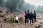 People look at the damage caused by Cyclone Freddy in Chilobwe, Blantyre, Malawi, March 13, 2023. 