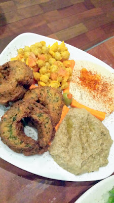 Darsalam Lazurdi Vegan Mezza Platter with Hummus, Baba ghanoush (smoky roasted eggplant ground with tahini, garlic, lemon juice and garnished with zaatar and olive oil), pickled mango salad, and three falafel (made from ground chickpeas and spices cooked to order from scratch)