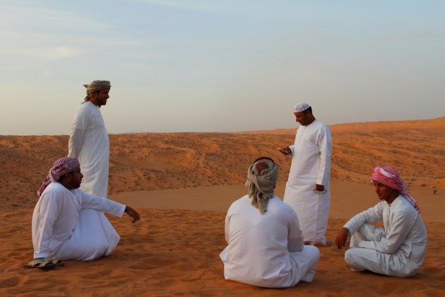 Omani men take a break from dune bashing at Wahiba Sands