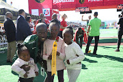 Comrades Marathon winner Edward Mothibi poses with his three daughters after winning the men's race in Durban on June 9 2019. 