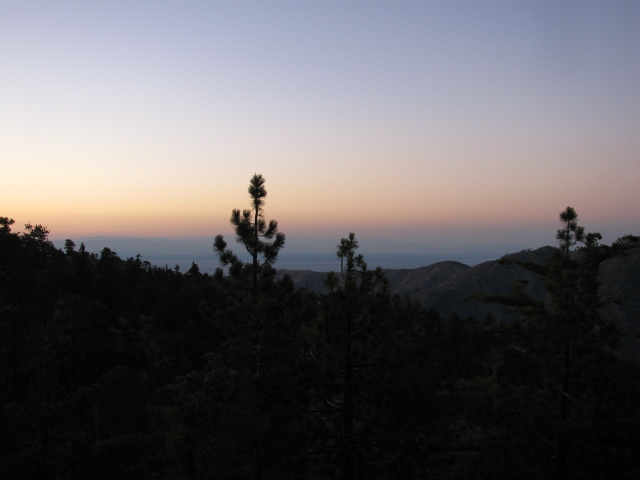 rounded mountains with pink sky above