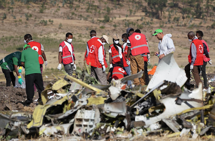 Forensics investigators and recovery teams collect personal effects and other materials from the crash site of Ethiopian Airlines Flight ET 302 on March 12 2019 in Bishoftu, Ethiopia. Picture: GETTY IMAGES/JEMAL COUNTESS