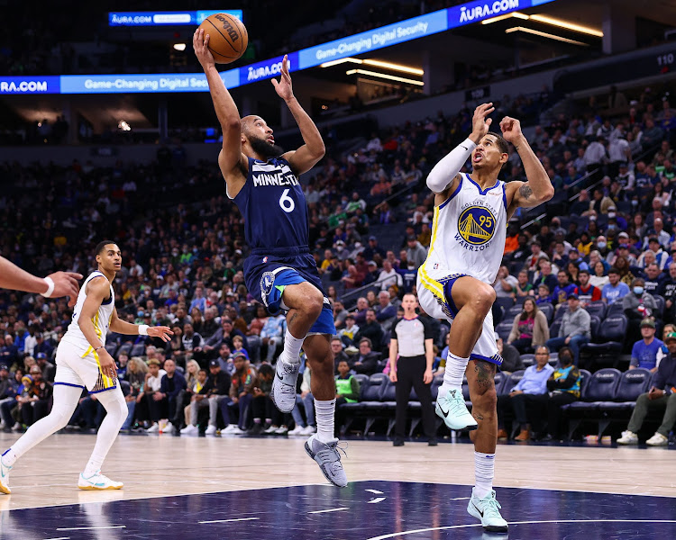 Minnesota Timberwolves guard Jordan McLaughlin (6) shoots the ball over Golden State Warriors forward Juan Toscano-Anderson (95) during the fourth quarter at Target Center.