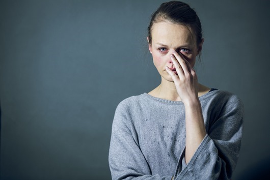 Young woman suffering from severe depression/anxiety/sadness, crying, tears coming from her eyes