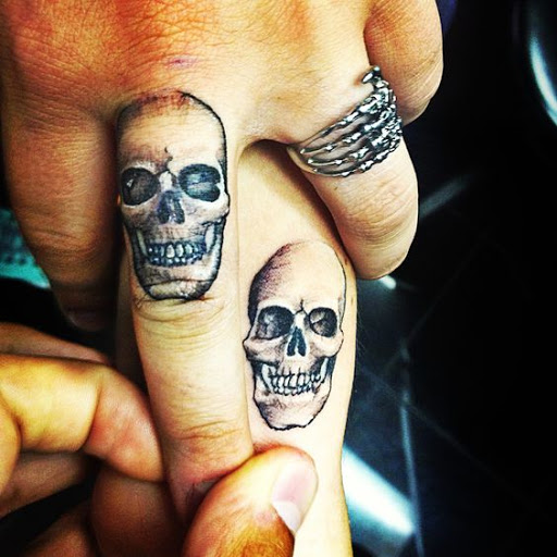 sugar skull finger tattoo