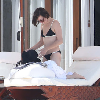 Milla Jovovich seen in bikini poolside while on vacation_40.jpg