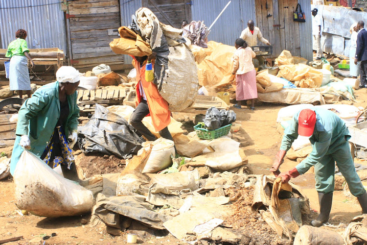 Traders relocate their belongings after shanties were demolished in Kabarnet open air market in Baringo on Tuesday.