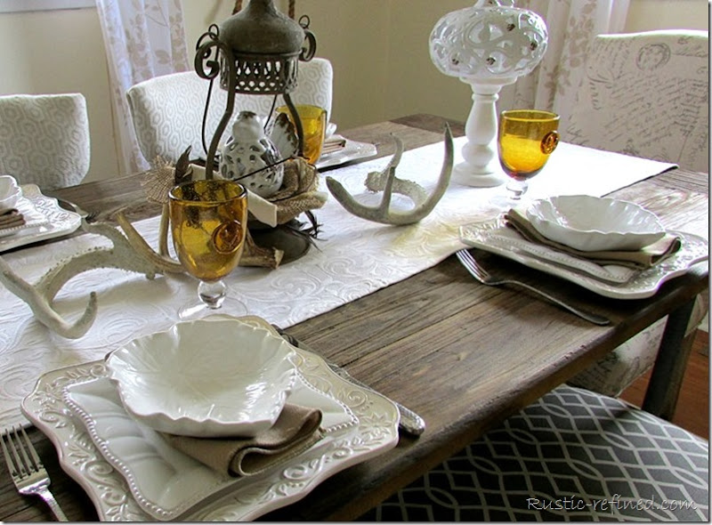 Farmhouse table using white dishes and antlers. Totally rustic!