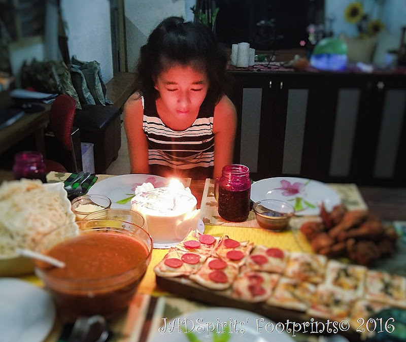 The blowing of the birthday cake after making a wish