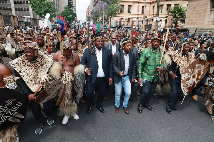 Prince Simphiwe Zulu, in green, with a group of amabutho outside the Pretoria high court pledging support for King Misuzulu ka Zwelithini.