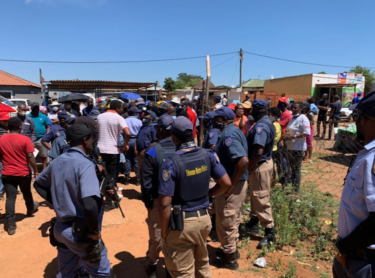 SAPS and Tshwane metro police officers calm irate Mamelodi East residents who tried to force their way into the voting station at the Life Giving Ministries church after learning that their names had apparently been left off the voters' roll.