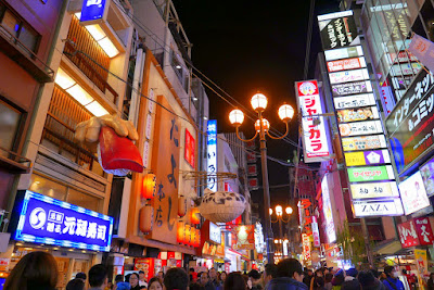 Sights of Osaka - the giant food signs of Dotonbori, including a giant sushi in a Big Hand that symbolizes Genroku Zushi and Zuboraya's fugu blowfish