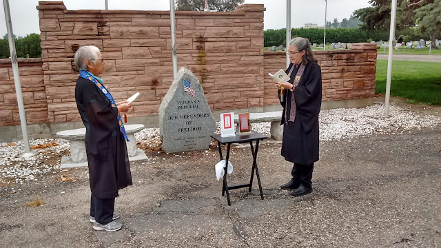 Buddhist ministers/ priests at cemetery Obon