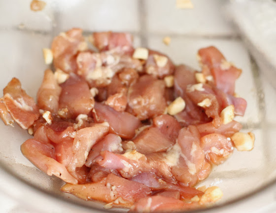 a process photo showing the chicken marinating in a bowl