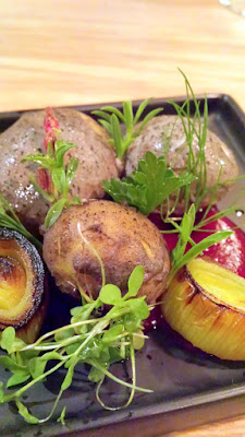 Filbert yogurt and ash coated potatoes with herbs on red beet kombucha with a River Rock presentation