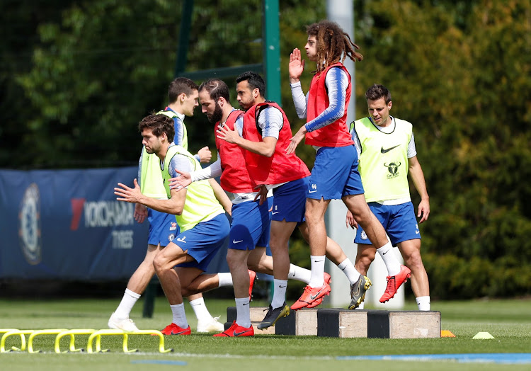 Chelsea's Marcos Alonso (L) with teammates during a training session