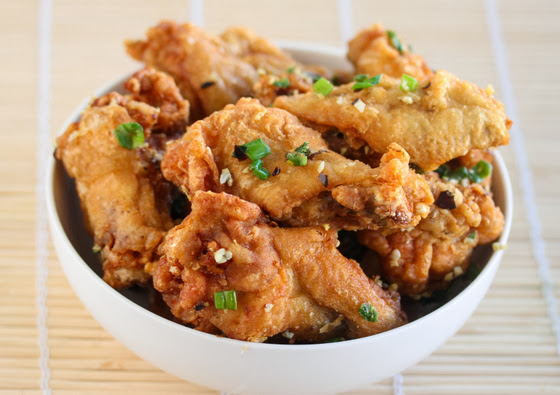 salt and pepper chicken wings in a white bowl